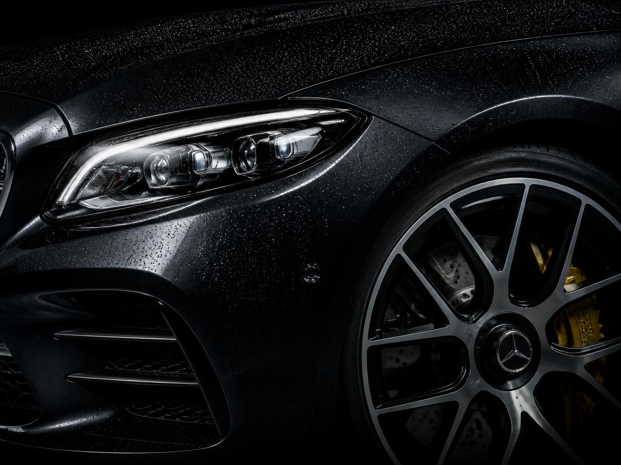 Close-up of a clean vehicle headlight and alloy wheel after servicing